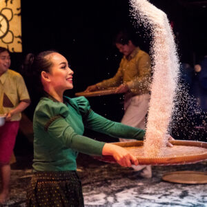 performer tossing rice in the air with a tray